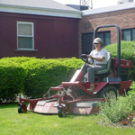 Image of man mowing lawn