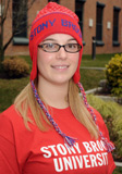 Photo of Student sitting outside with SB logo shirt on