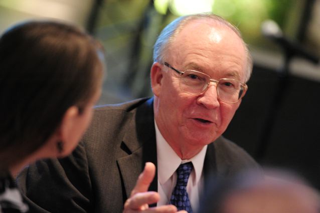 Dr. Rohlf making a point while in conversation with others at the reception