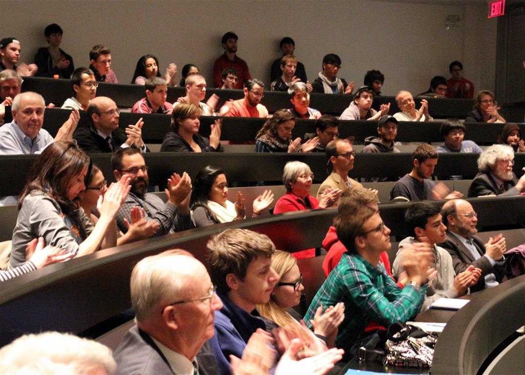 The audience in the lecture hall applauding to thank Dr. O'Higgins' for his lecture