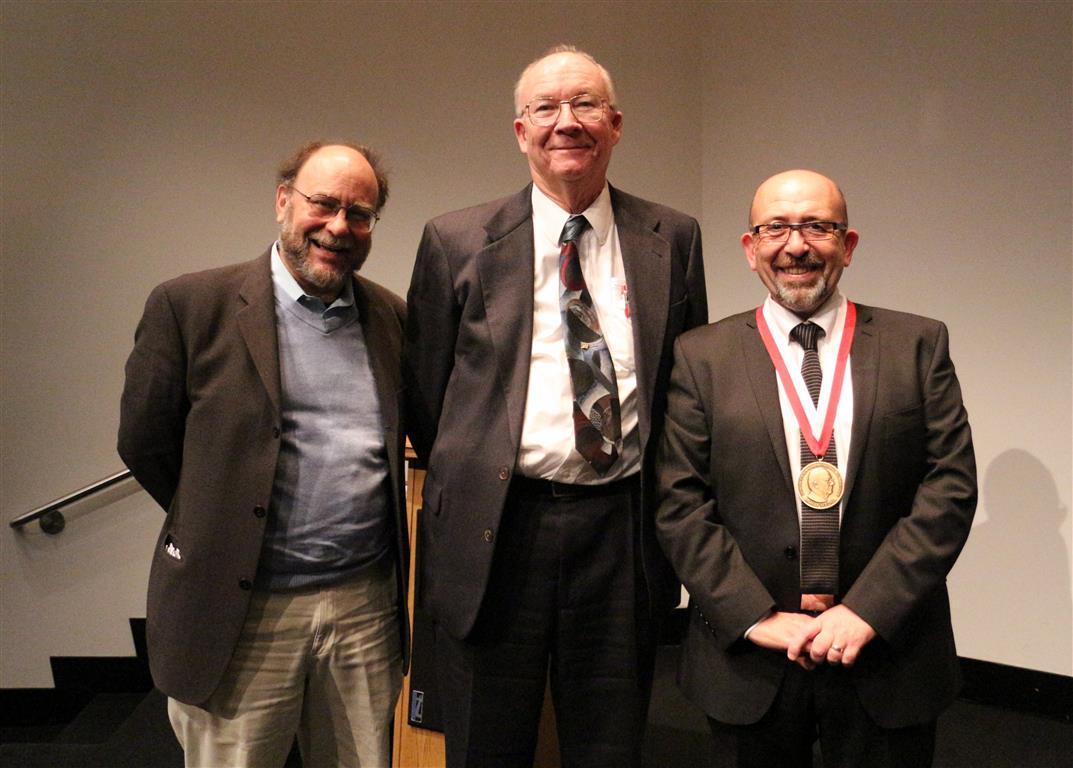 Posed photograph of Bookstein, Rohlf, and O'Higgins with his medal