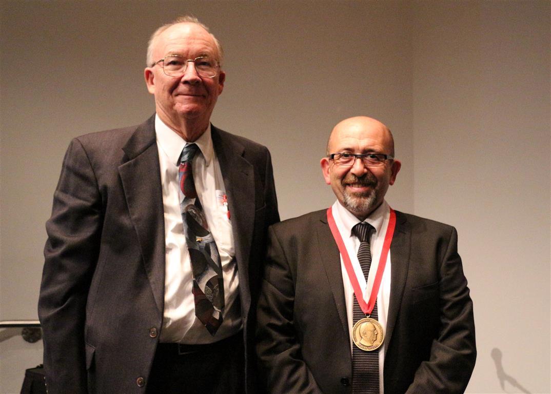 Posed photograph of F. James Rohlf and Paul O'Higgins wearing his medal