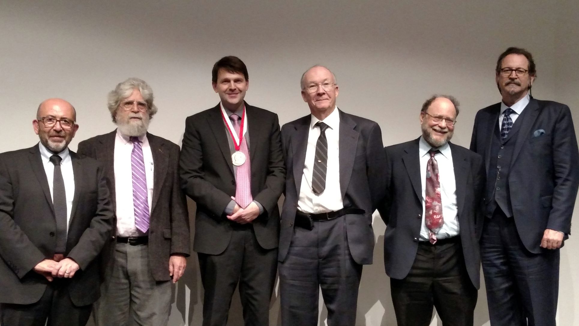Posed photo of Hallgrímsson standing with Rohlf Medal committee