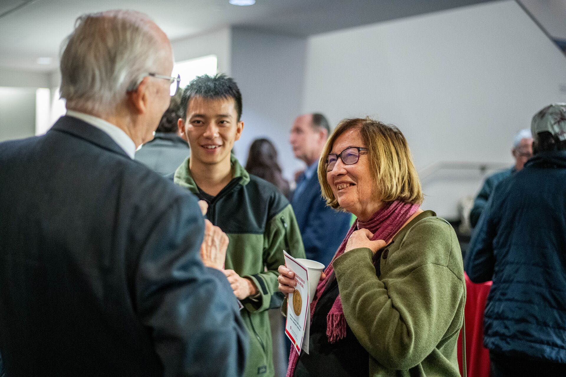 Photograph of Rohlf Medal Reception attendees chatting with F. James Rohlf
