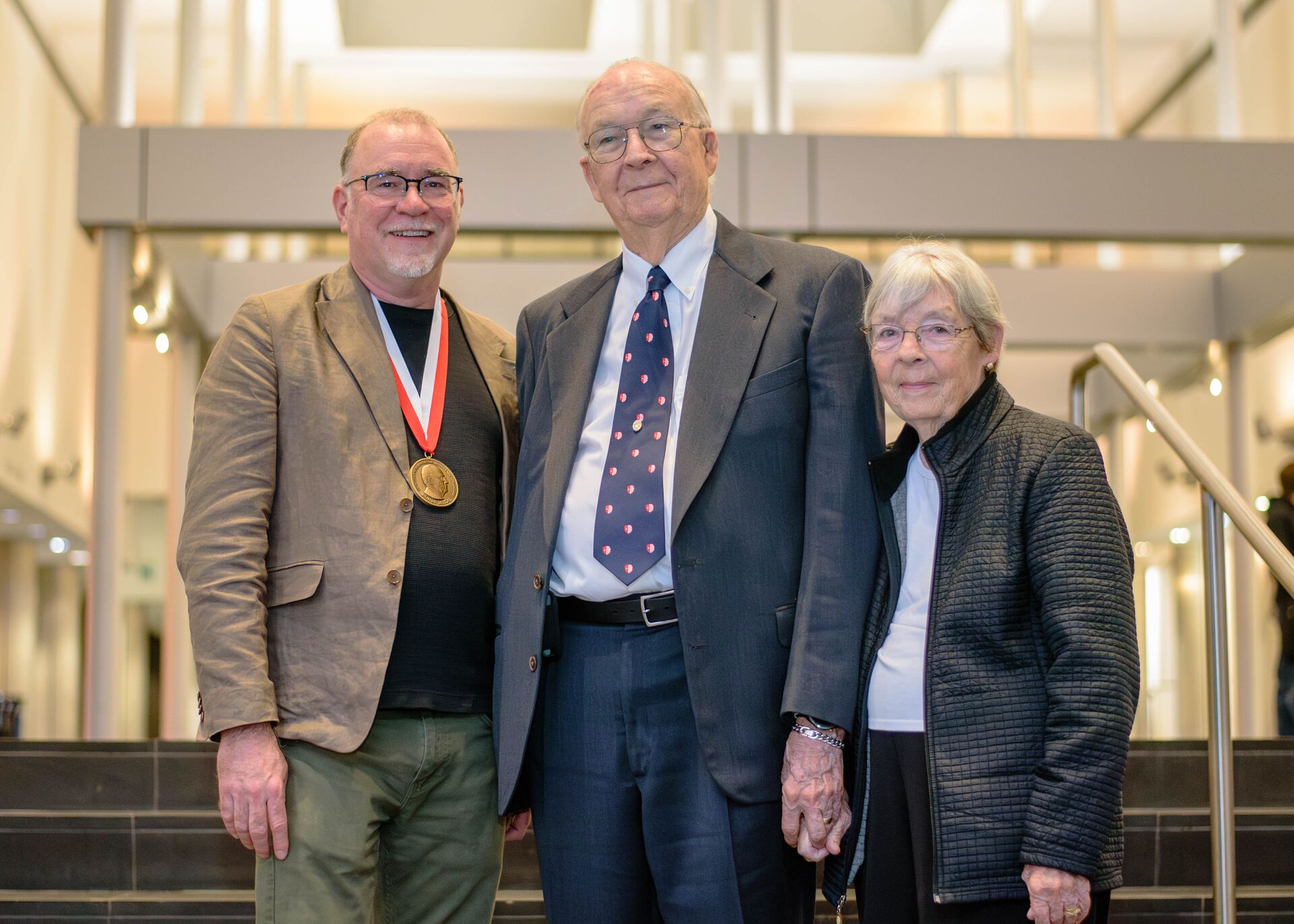 P. David Polly weaing his medal, standing with Jim and Janice Rohlf