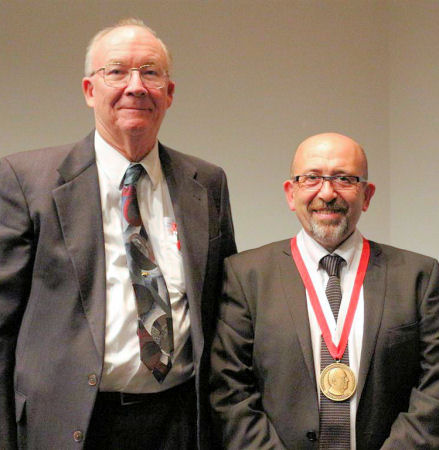 Paul O'Higgins wearing his Rohlf Medal and standing next to Jim Rohlf