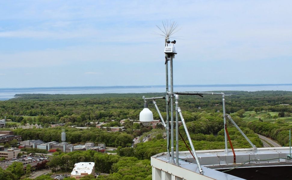 The weather station and camera on the roof of the Health Sciences Center overlooking the Stony Brook University campus.