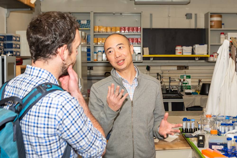 Ed Luk speaking in the lab