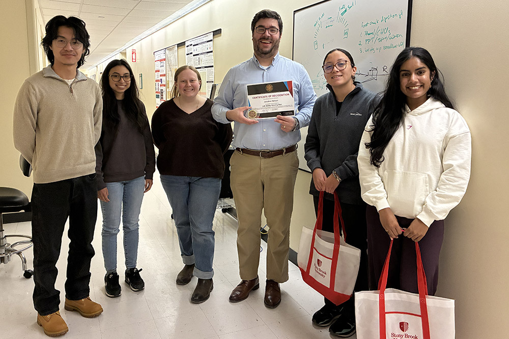 The Nelson lab displaying their award