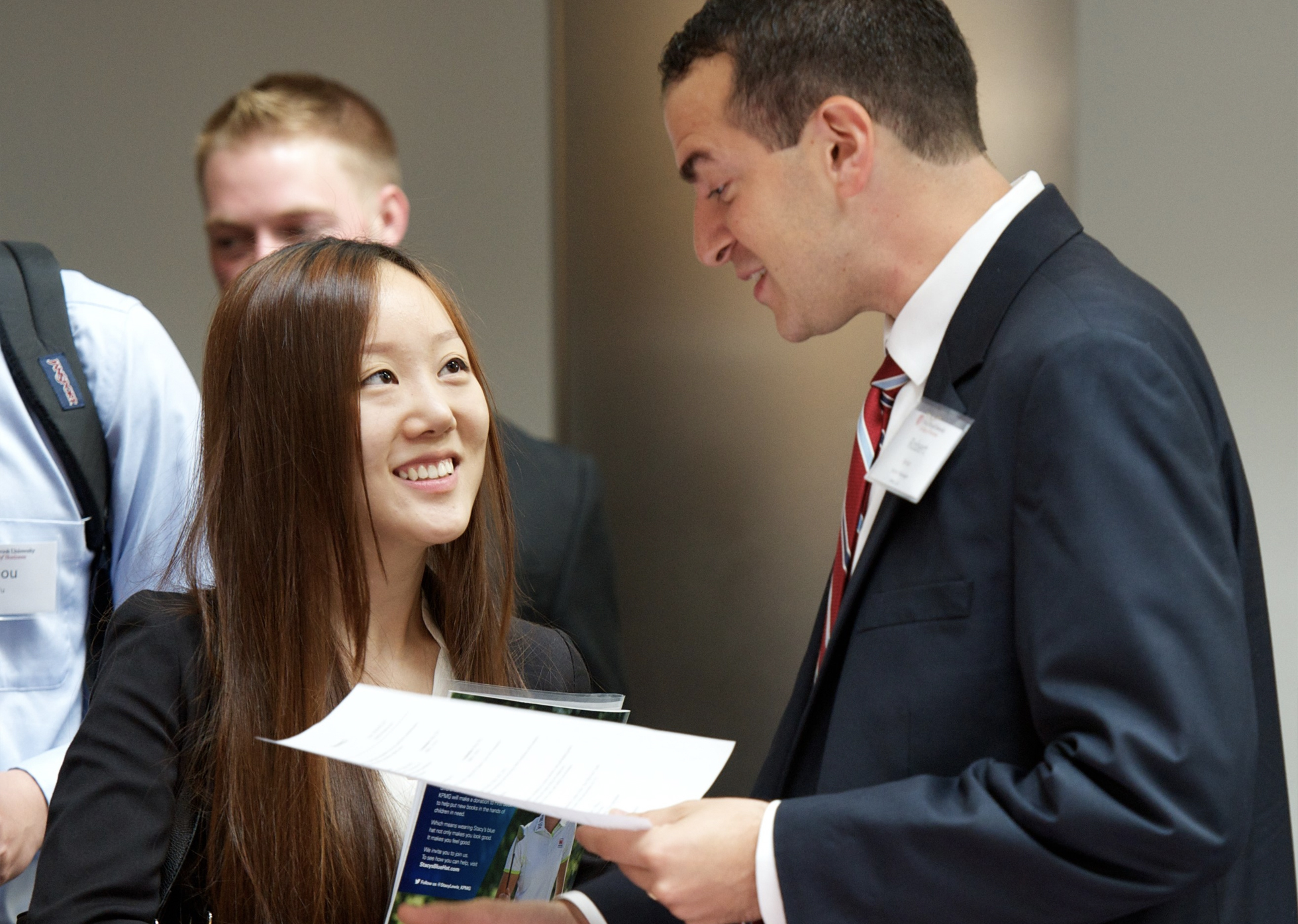 student sharing resume with employer at event