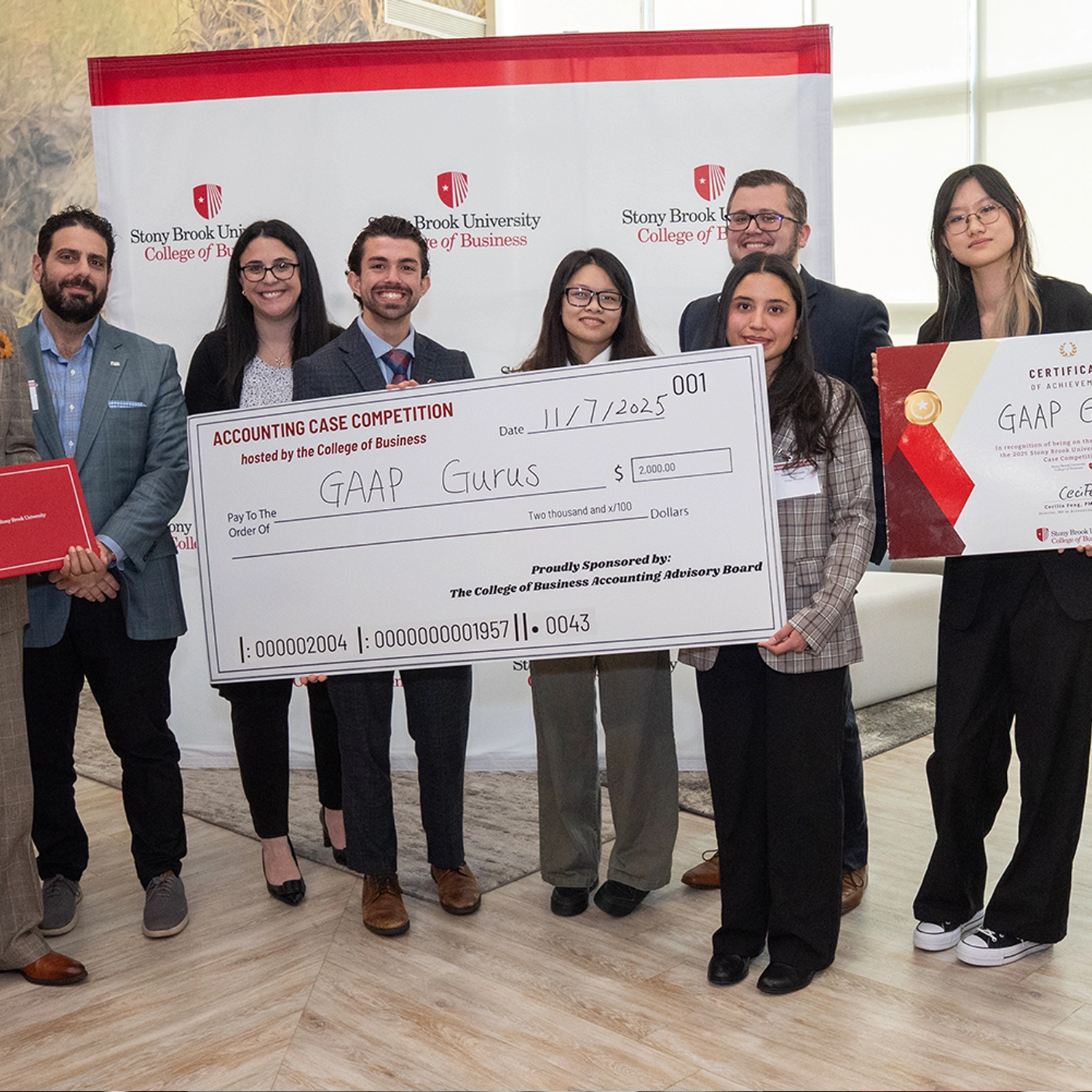 students holding big check