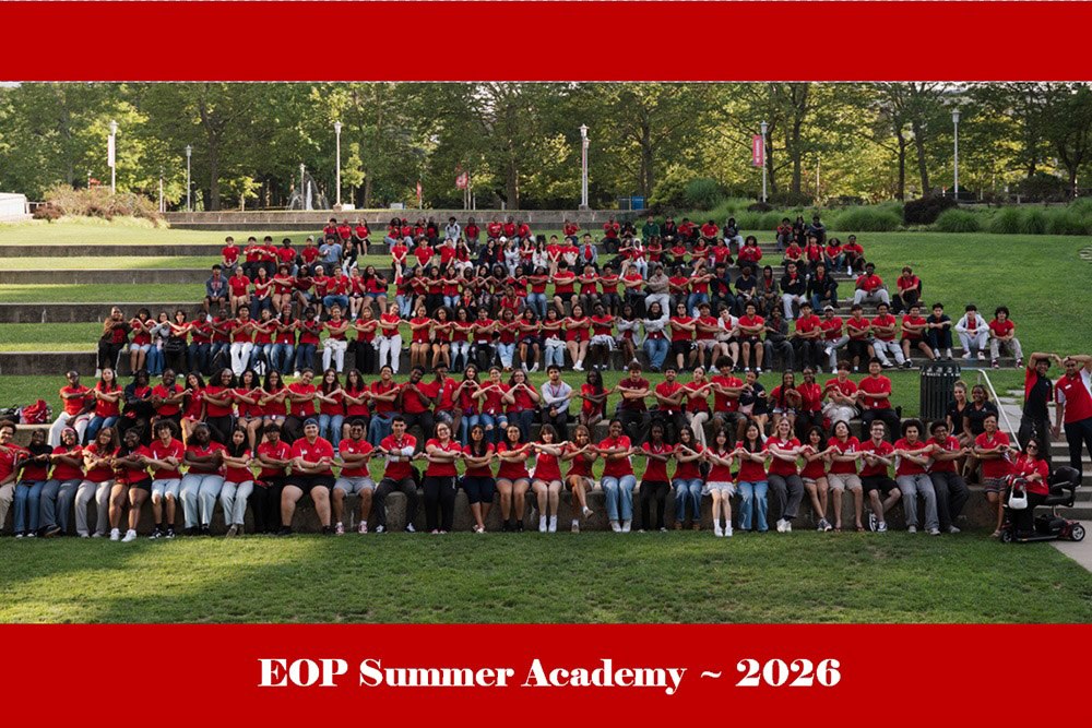 Group photo of students sitting in the grass holding hands with text that reads "EOP Summer Academy 2026"