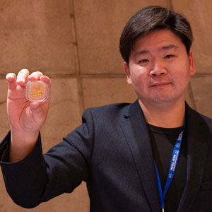 Chuck Choi holding quantum network in his hand.