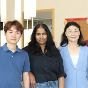 Three people standing and posing for the camera.