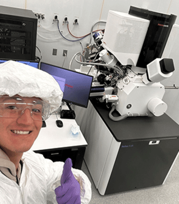 Cade Thompson posing with microscope and computer