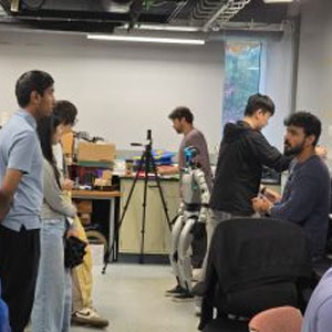 Students interacting with a humanoid robot in a classroom environment.