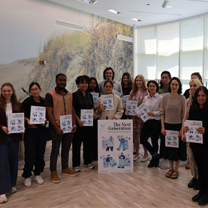 Group of students holding up light blue magazines that read "The Next Generation"