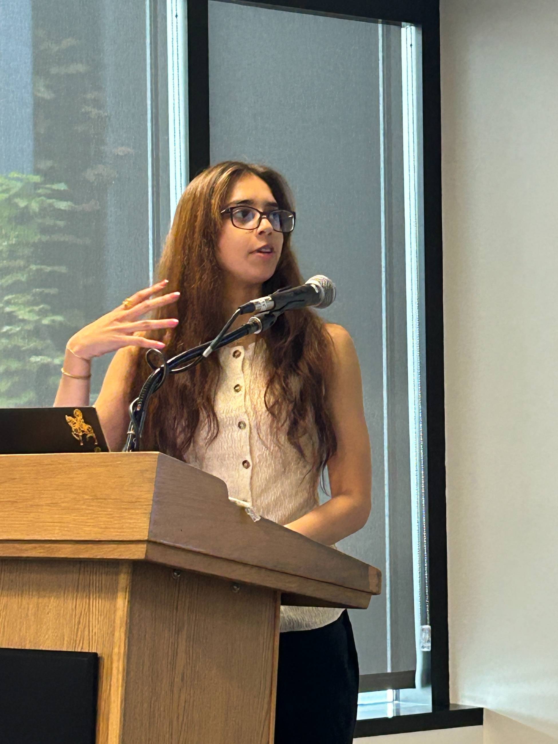 Sujata Tank presenting at podium