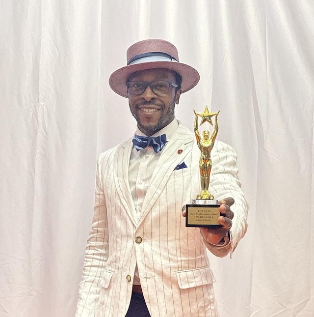 image of Stony Brook MFA in Film alum Nnamdi Nwosa with award at TINFF