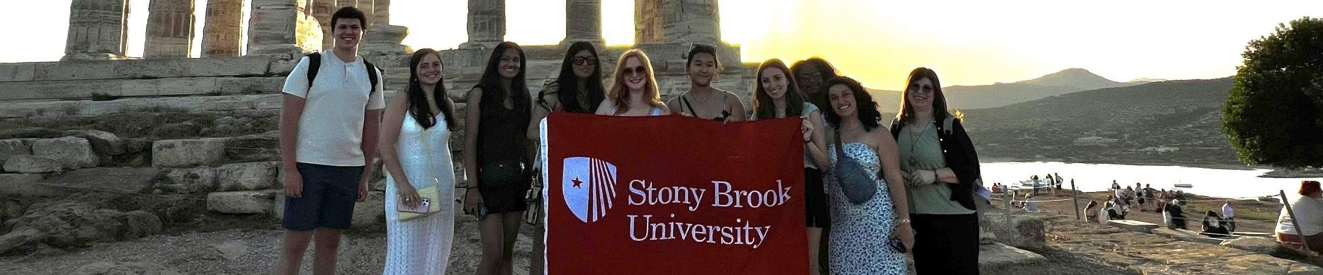Students holding a "Stony Brook University" sign