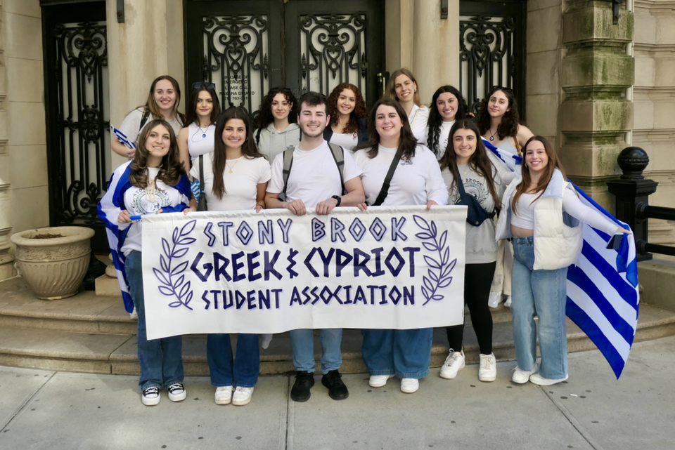 Students holding a sign that says "Stony Brook Greek & Cypriot Student Association"