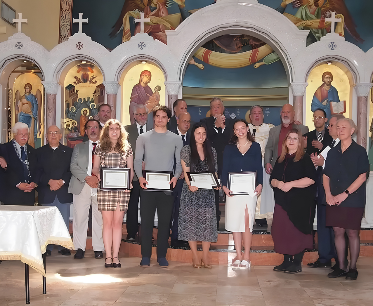 Line of students holding certificates