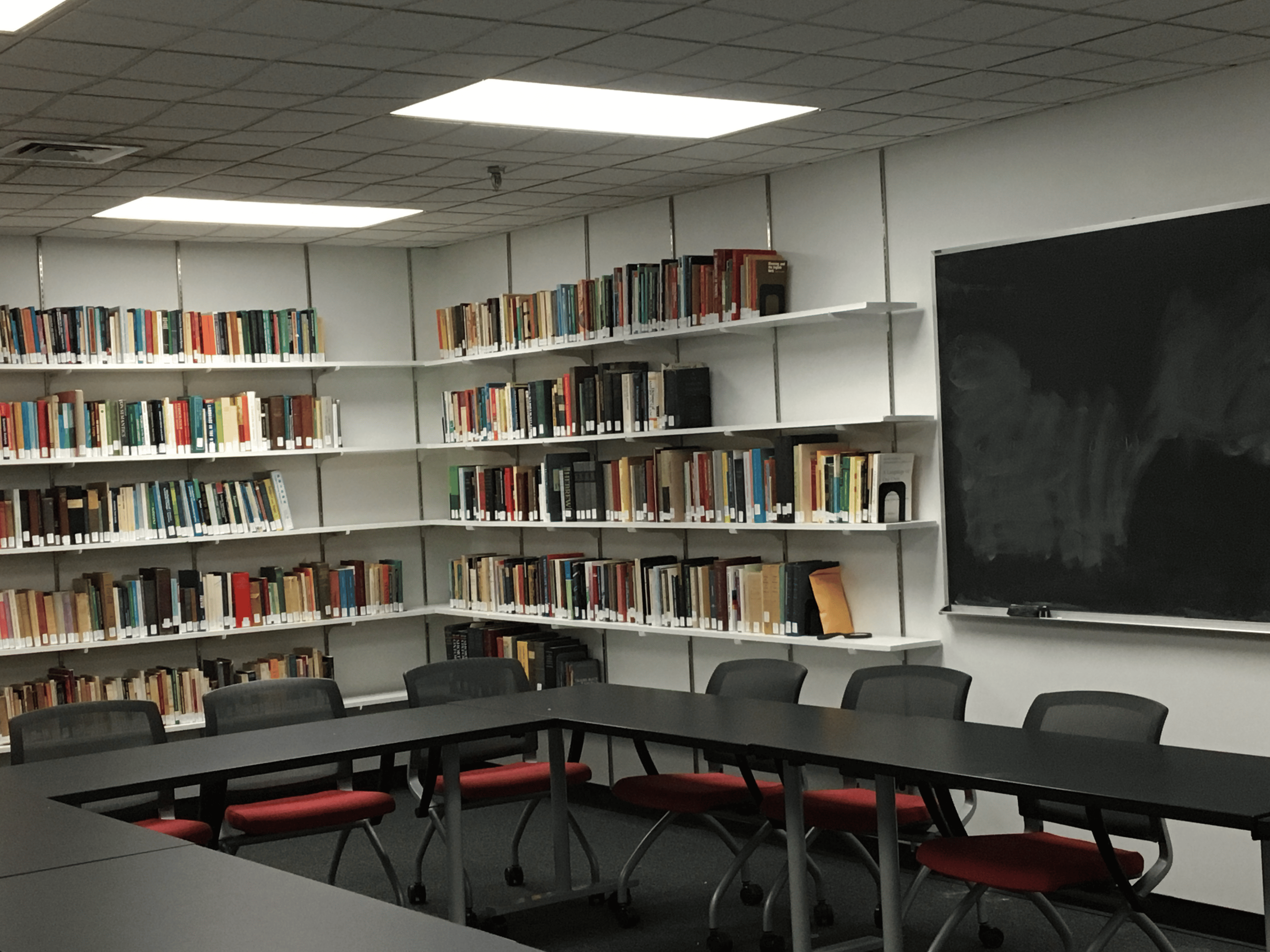 Room with chairs and books on shelf