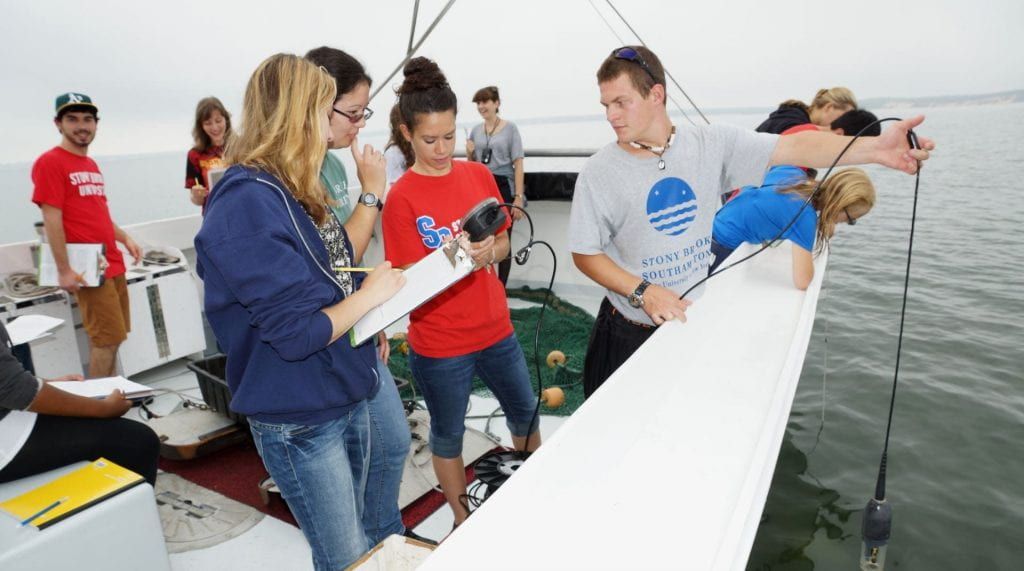 Students conducting oceanographic work onboard a research vessel