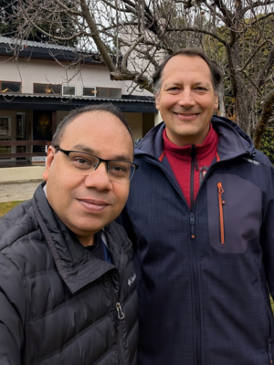 Professor Purwar and host faculty Prof. Garcia stand in front of  a newton tree outside the Instituto Balseiro