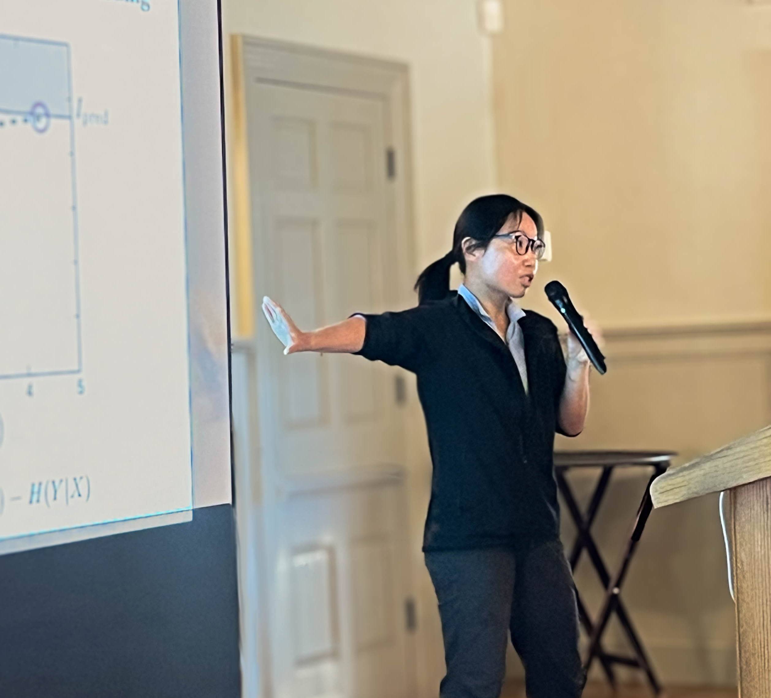 Person speaking in front of a projector