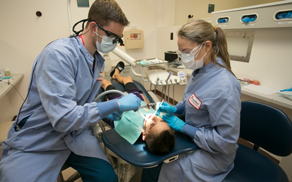 Two students in dental classroom setting