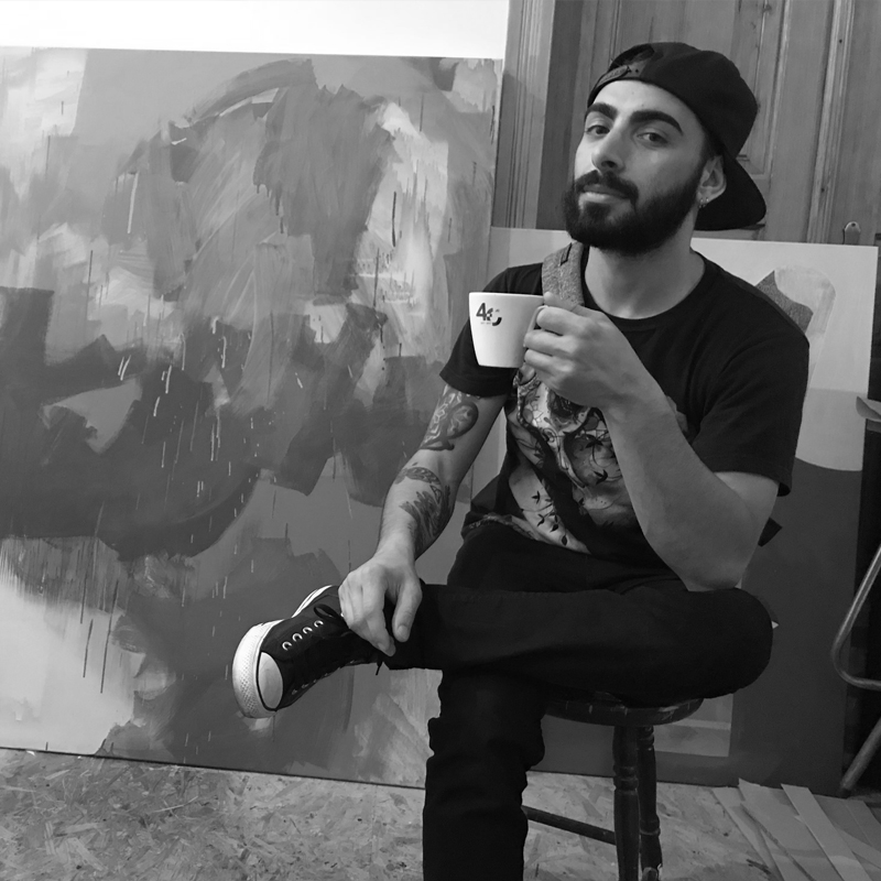 Eric Murphy Sitting on a stool with his coffee