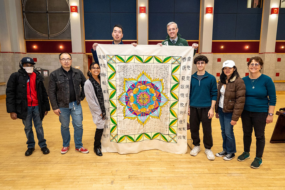 CBC members and students holding up finishes painted mandala 