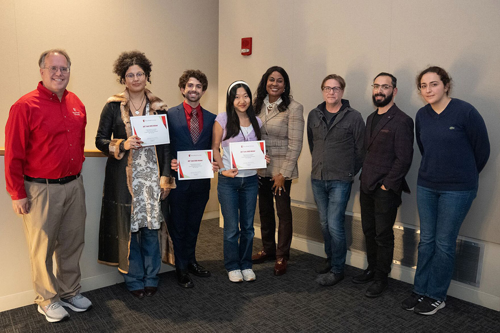 art tank winners and judges standing together with the winners certificates in their hands