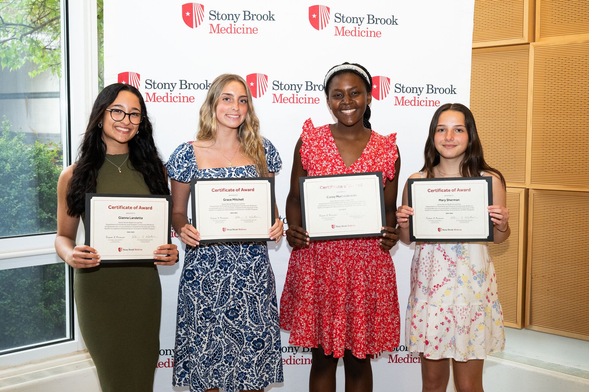 Graduating seniors in the HOPE Program accept awards.