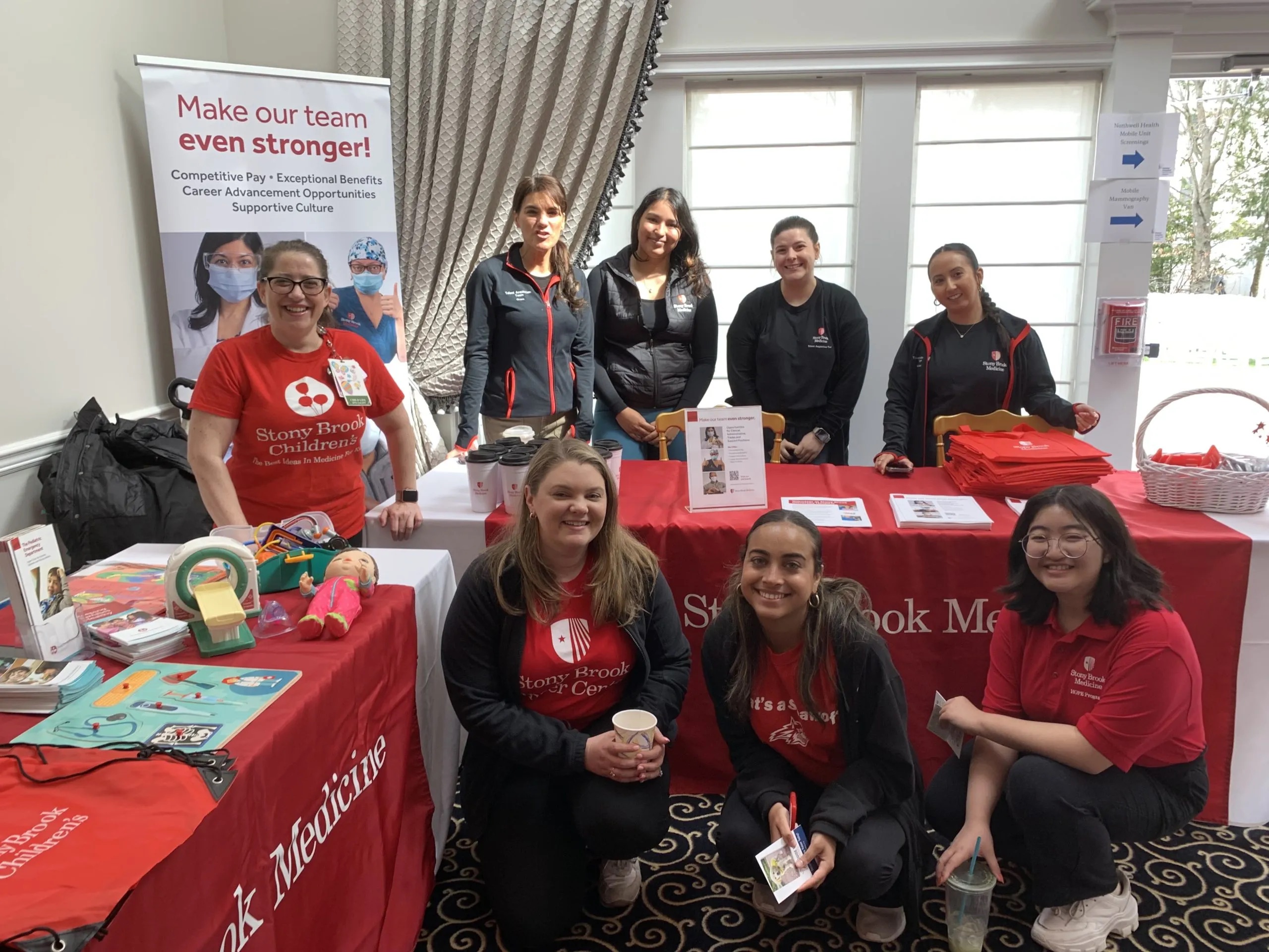 Stony Brook Medicine staff members pose for a photo at a health and wellness fair.