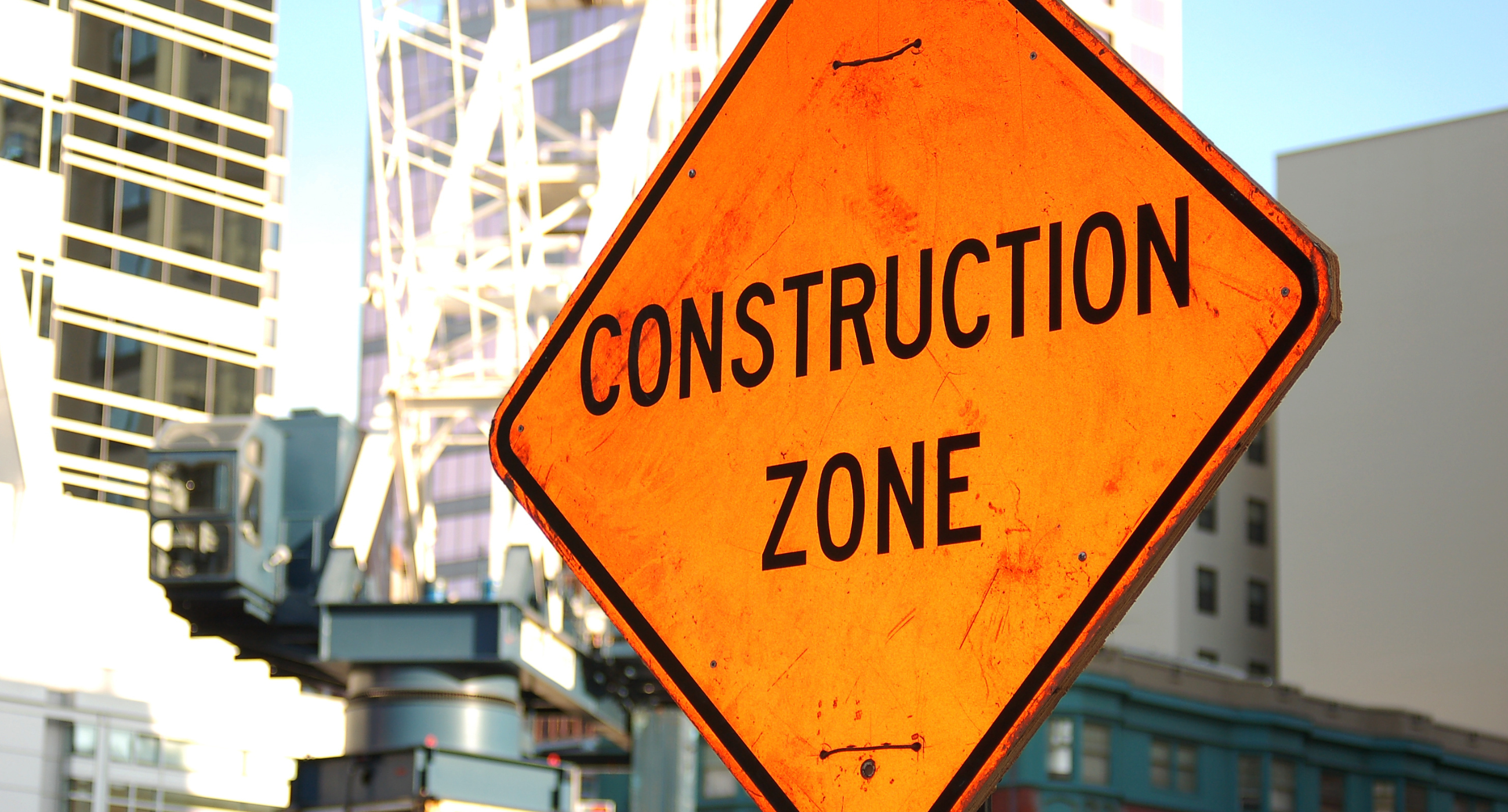 construction zone sign in foreground construction zone background