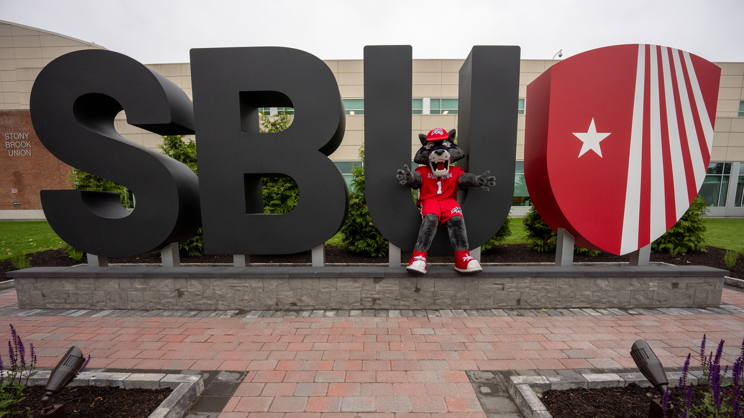 Wolfie mascot in front of SBU large letter installation