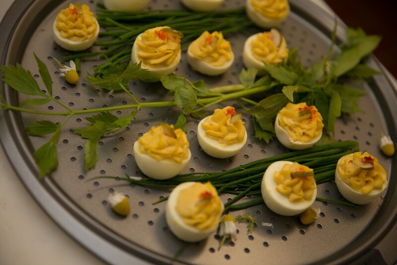 A prepared tray of deviled eggs and fresh herbs