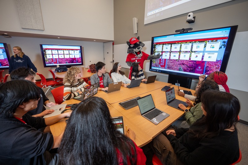 Stony Brook students and mascot connecting in a campus classroom