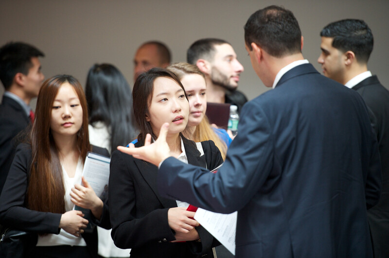 Students speaking with employers at a recruiting event