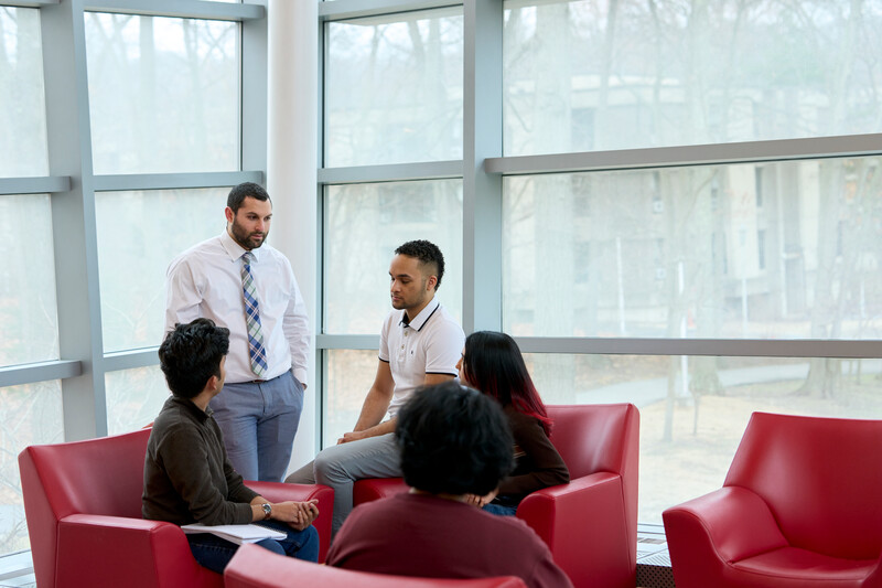 Colleagues having a discussion in a university lounge