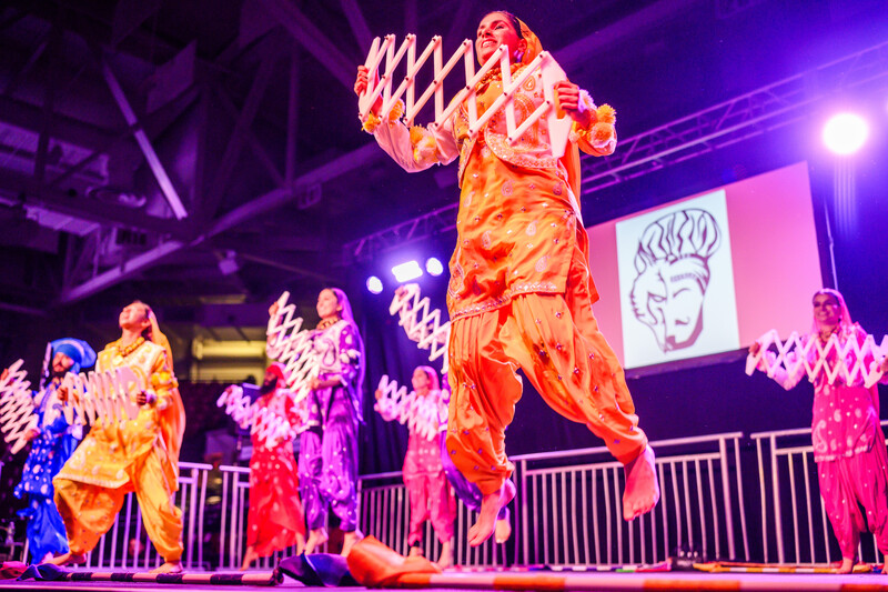 Dancers performing on a colorful stage