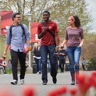 Three students walking on campus