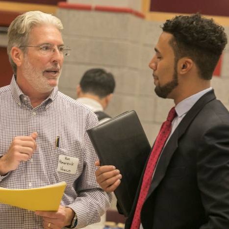 Student talking to an employer at a career fair