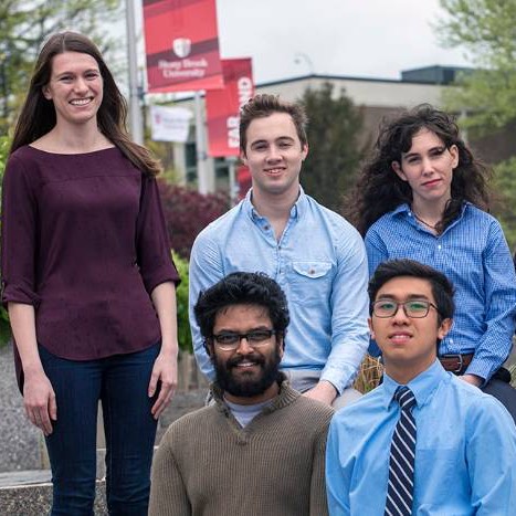 Five students posing on campus