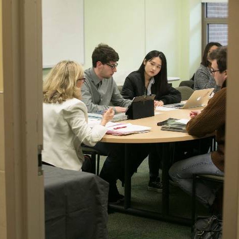 Five people meeting at a conference room table