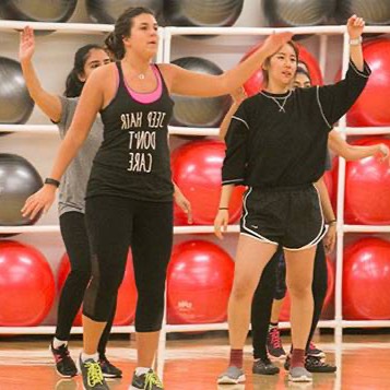Girls taking an aerobics class in front of yoga balls
