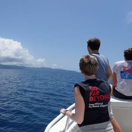 SBU students in a boat looking out at the water