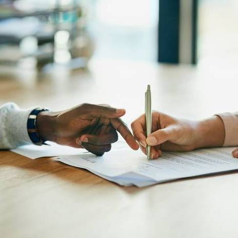 Hands pointing to a document on a table